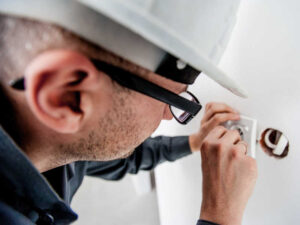 Image of a man doing electrical work.