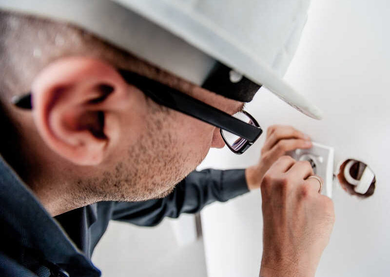 Image of a man doing electrical work.